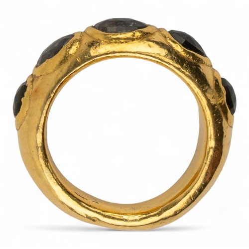 6 - Indian, A high-carat gold band ringSet to the front with five oval-shaped rose-cut greenish foiled s... 
