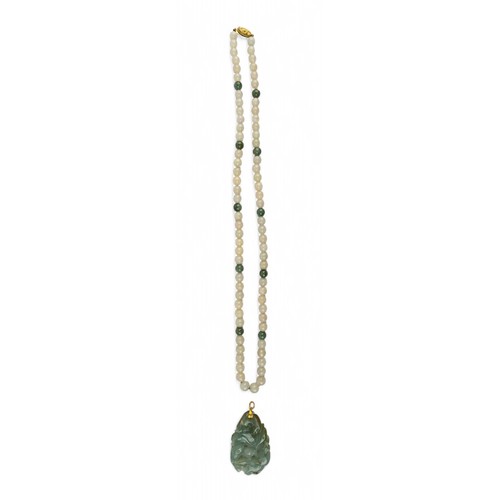 22 - A pale celadon and green nephrite bead necklaceTogether with a carved jadeite carp and lotus scroll ... 