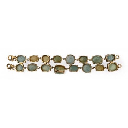 25 - An unusual cabochon aquamarine and beryl braceletComposed of two rows of circular cabochon aquamarin... 