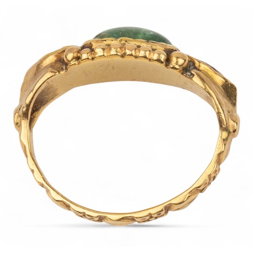 26 - Antique, IndianA gold and gem-set ringThe top set with an oval-shaped cabochon emerald, flanked by p... 