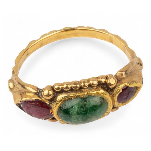 26 - Antique, IndianA gold and gem-set ringThe top set with an oval-shaped cabochon emerald, flanked by p... 
