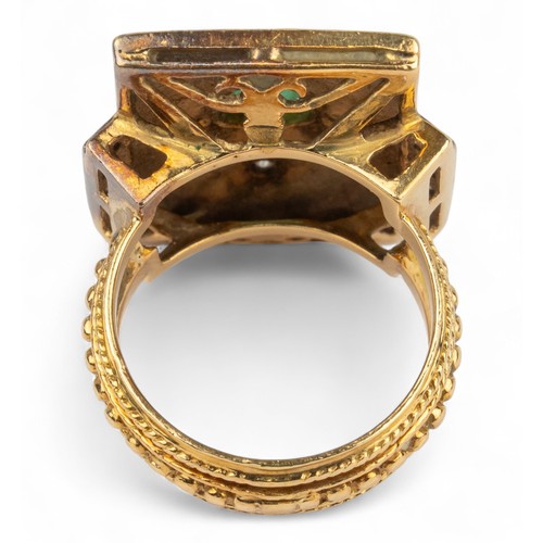 33 - An 18k gold, emerald and diamond dress ringThe rectangular top set to the centre with an oval-shaped... 