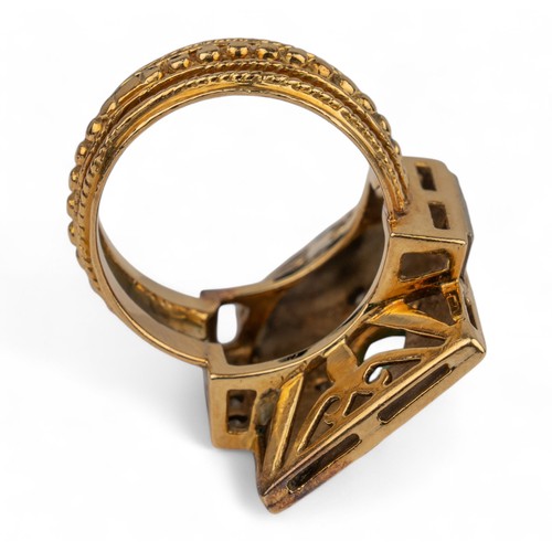 33 - An 18k gold, emerald and diamond dress ringThe rectangular top set to the centre with an oval-shaped... 