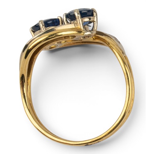 47 - A sapphire and diamond crossover ringThe two circular-cut sapphires set in crossover formation, with... 