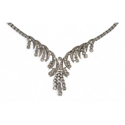 60 - Circa 1960s, A diamond necklaceThe scrolled front set with circular and brilliant-cut diamonds. With... 