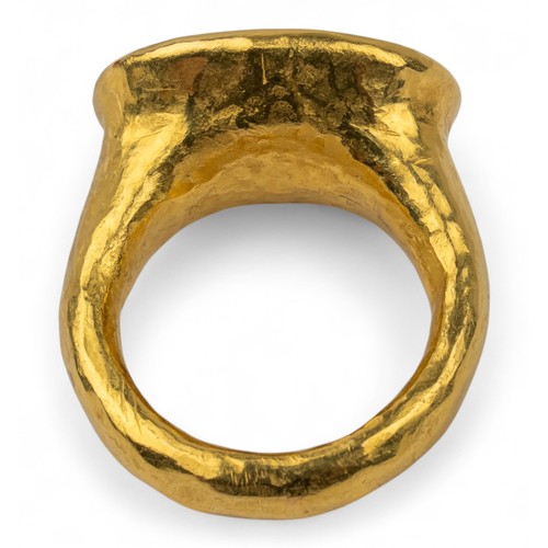 58 - A ruby and high-carat yellow gold dress ringThe top inset wit a large oval-shaped treated ruby. With... 