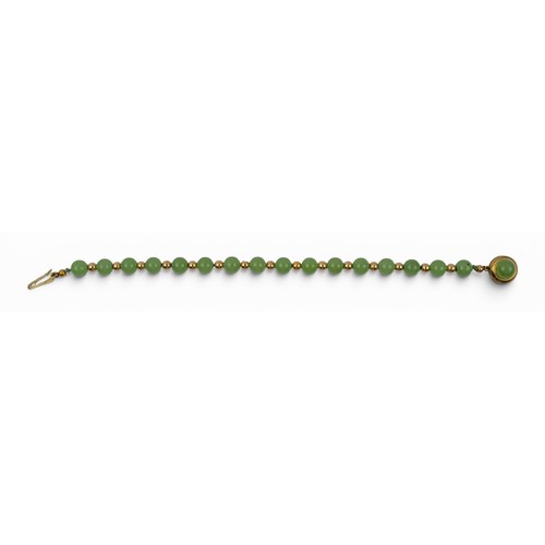 10 - A nephrite and 9ct gold braceletThe 6.8 mm. beads of pale green colour, strung with gold ball spacer... 