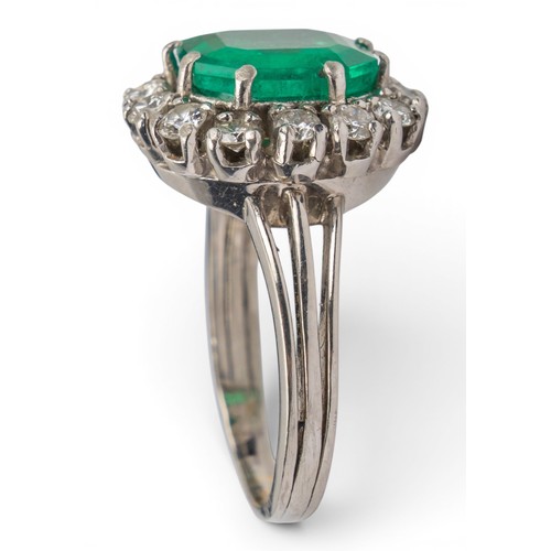 43 - A fine Colombian emerald and diamond cluster ring, circa 1950The octagonal-cut emerald weighing appr... 