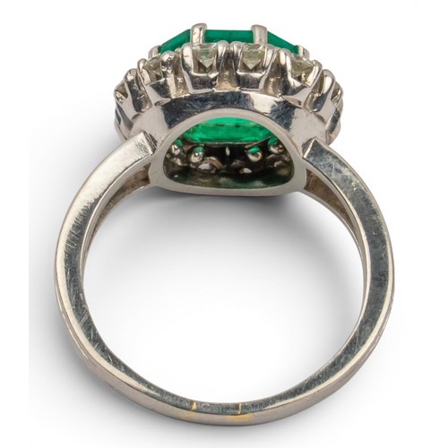 43 - A fine Colombian emerald and diamond cluster ring, circa 1950The octagonal-cut emerald weighing appr... 