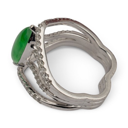 44 - A fine jadeite and diamond cluster dress ringThe central marquise-shaped highly translucent emerald ... 