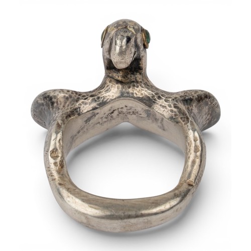 47 - Mosheh Oved, A silver and gold parrot ring, circa 1950The neck modelled and engraved to display plum... 