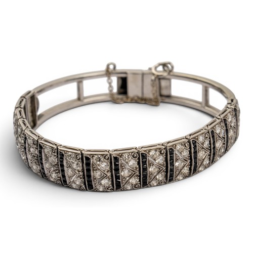 51 - An attractive Art Deco diamond and onyx braceletThe front composed of fifteen stylised pierced secti... 