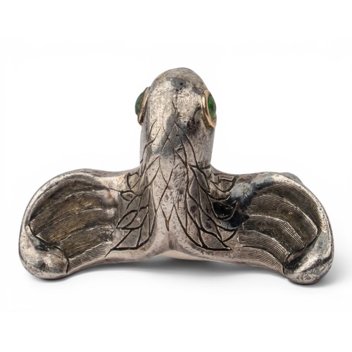 47 - Mosheh Oved, A silver and gold parrot ring, circa 1950The neck modelled and engraved to display plum... 