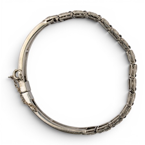 51 - An attractive Art Deco diamond and onyx braceletThe front composed of fifteen stylised pierced secti... 