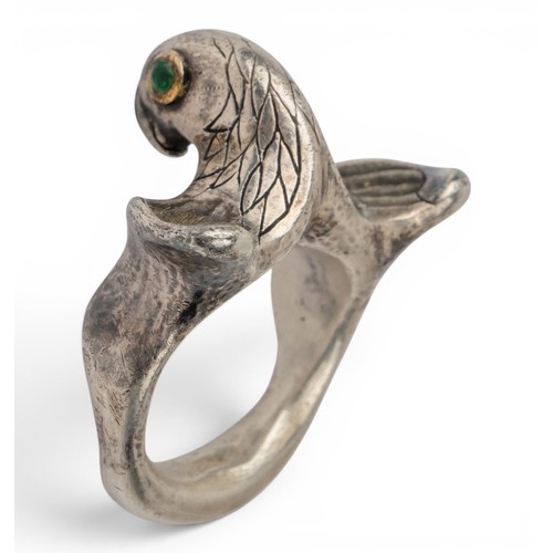 47 - Mosheh Oved, A silver and gold parrot ring, circa 1950The neck modelled and engraved to display plum... 