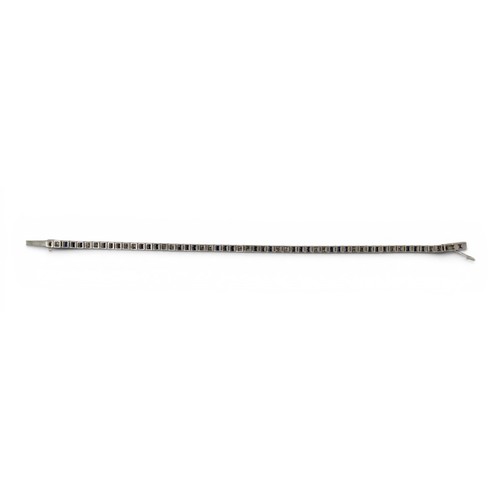 48 - Cartier, Paris, A fine calibre-cut sapphire and diamond line braceletDesigned as alternate rows of t... 
