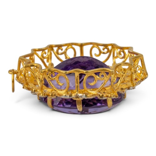 26 - Antique-style, An amethyst, diamond and ruby cluster pendantThe oval mixed-cut amethyst of pretty co... 