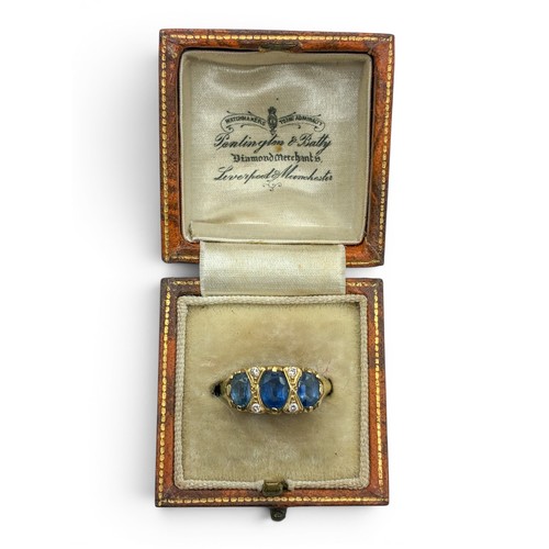16A - A sapphire, diamond and 18ct gold three-stone ringThe three lightly graduated oval-shaped mixed-cut ... 