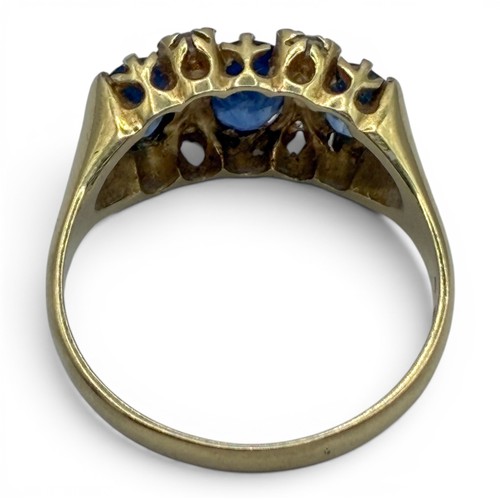 16A - A sapphire, diamond and 18ct gold three-stone ringThe three lightly graduated oval-shaped mixed-cut ... 