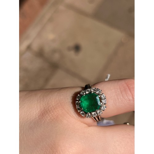 43 - A fine Colombian emerald and diamond cluster ring, circa 1950The octagonal-cut emerald weighing appr... 