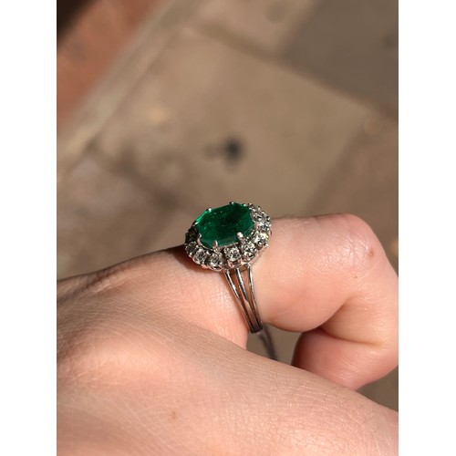 43 - A fine Colombian emerald and diamond cluster ring, circa 1950The octagonal-cut emerald weighing appr... 