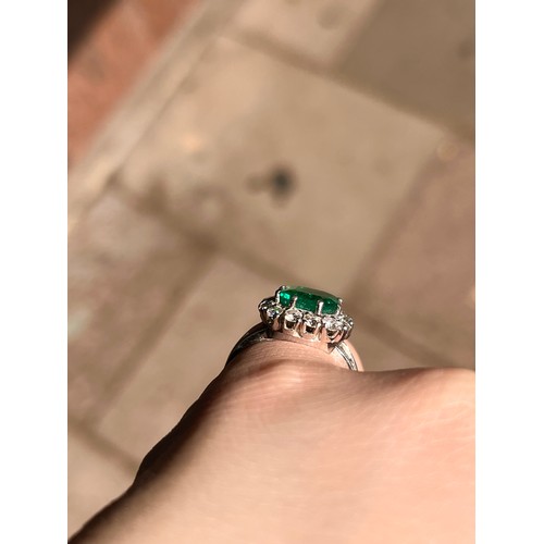 43 - A fine Colombian emerald and diamond cluster ring, circa 1950The octagonal-cut emerald weighing appr... 