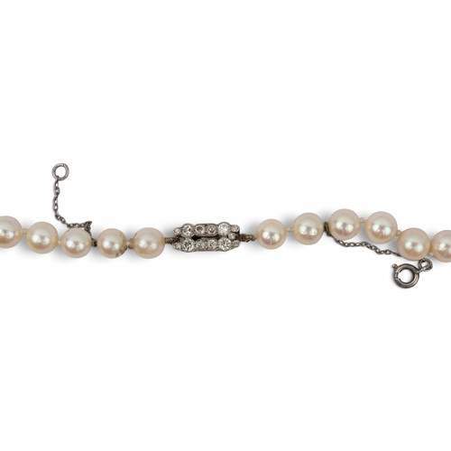 43 - A slightly graduated cultured pearl necklace with diamond clasp, circa 1930Composed of fifty-three p... 