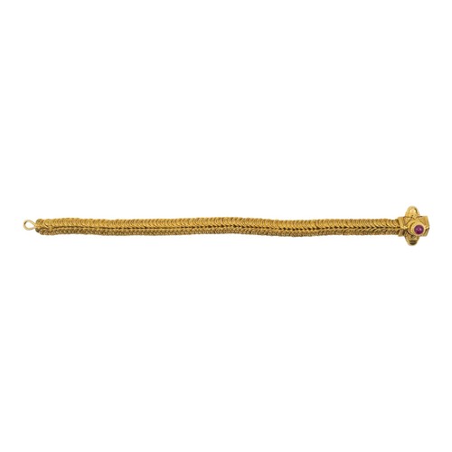 20A - Indian, 20 century, A high-carat gold and ruby flexible braceletThe flexible scale-link gold bracele... 