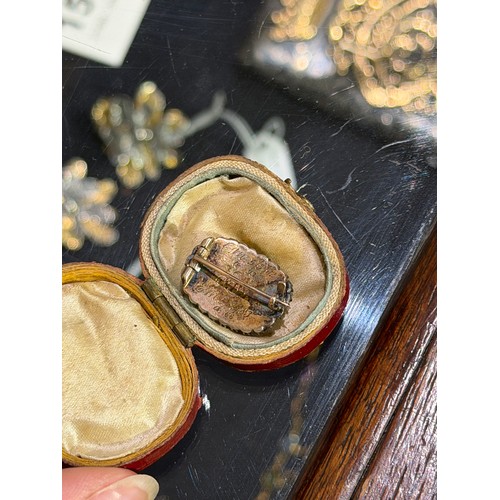 27 - Georgian, A diamond-set memorial brooch in original caseThe oval-shaped glazed plaited hair, within ... 