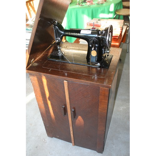 73 - Cased Singer Sewing Machine in Original Cabinet (note attachments in carousel)