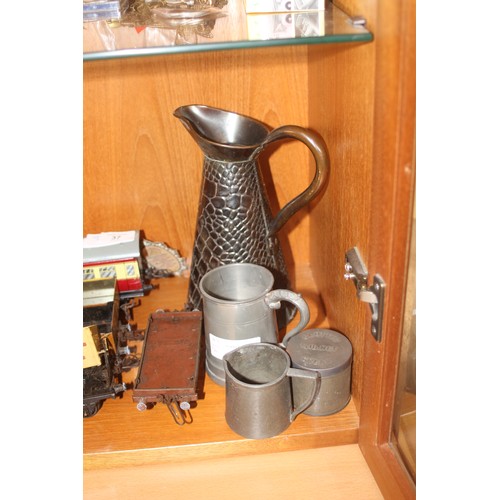 38 - Four Items of Pewter-Ware:  Two Jugs, a Lidded Tin and a Mug