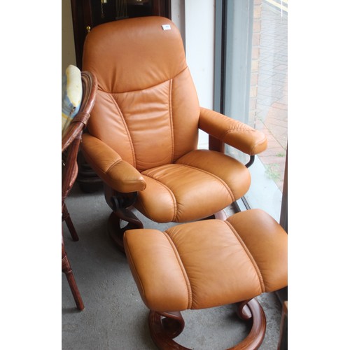 243 - An Ekornes Tan Leather Recliner Adjustable Chair and Footstool