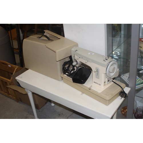 77 - Merritt Electric Sewing Machine in a Hard Plastic Case with Foot Pedal Attachment