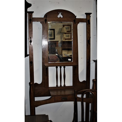 6 - An Oak Arts and Crafts Hall Stand having 8 Original Hooks, Umbrella Stands and Small Central Drawer ... 