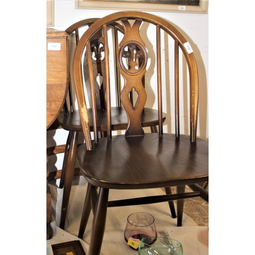 119 - Two Ercol Hoop Back Dining Chairs having Fleur De Lys Detail (with Blue and Gold Stickers)