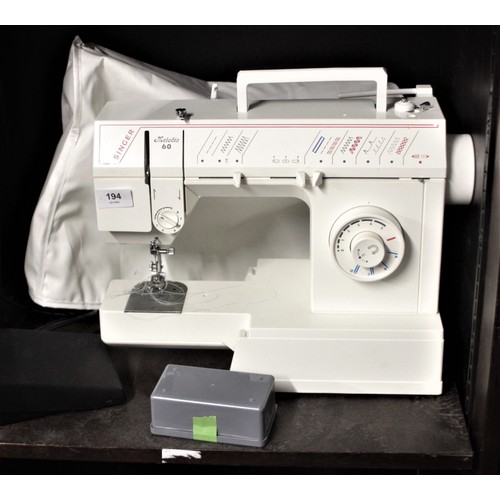 187 - Singer Melodie 60 Electric Sewing Machine and Accessories (vgc) with a soft cover