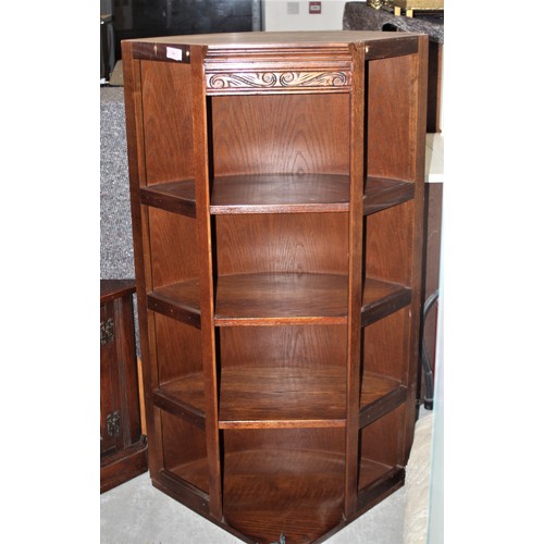 263 - A Dark Oak Carved Four-Shelf Unit having a Rounded Back and a Corner Style Front