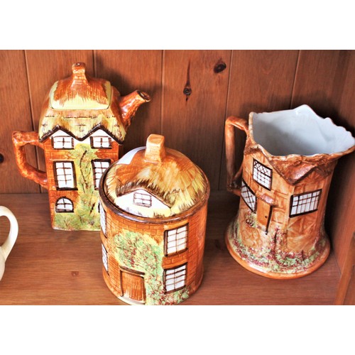 106 - Three Pieces of Cottage Ware:  Storage Jar, Jug and Teapot