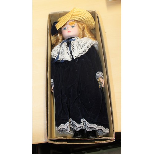 198 - A Boxed Alberon Collectors' Porcelain Doll Wearing a Blue Dress, Straw Hat and Spectacles