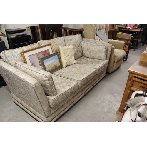 219 - A Slumberland Sofa Upholstered in Pale Coloured Fabric - on Casters