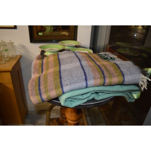 203 - Two Woollen Blankets/Lap Rugs:  One in Pale Green having an Ecclesiastical Label, and one Made by 