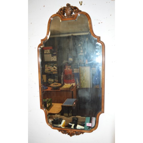 190 - An Irregular Shaped Bevel Edge Mirror in an Ornate Walnut Frame