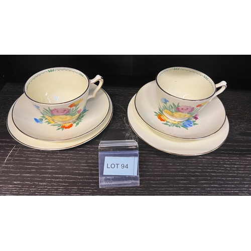 94 - Pair of rare Crown Staffordshire floral uranium glaze cups and sauces. (They glow)