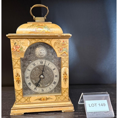 149 - Brass faced small cream lacquered bracket clock with carrying handle, working with key
