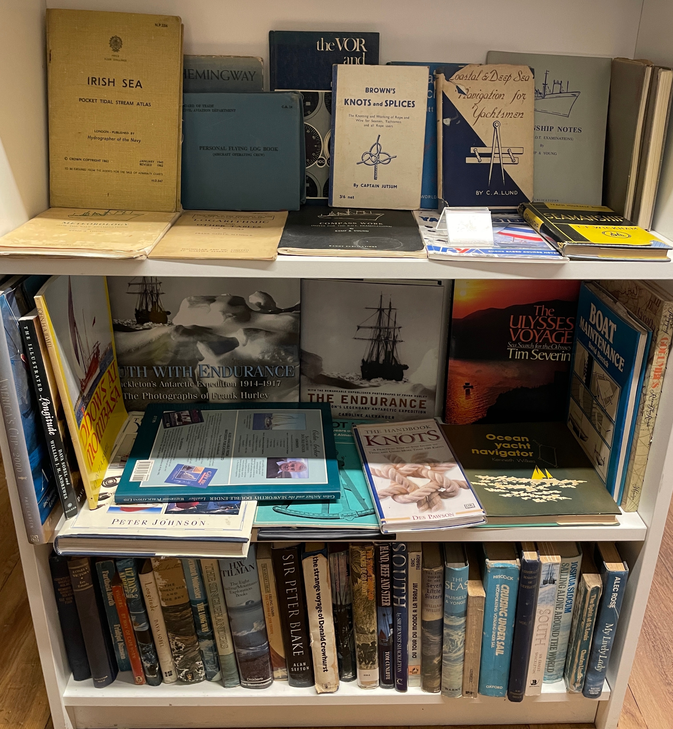 A large shelf collection of maritime and nautical books, including ...