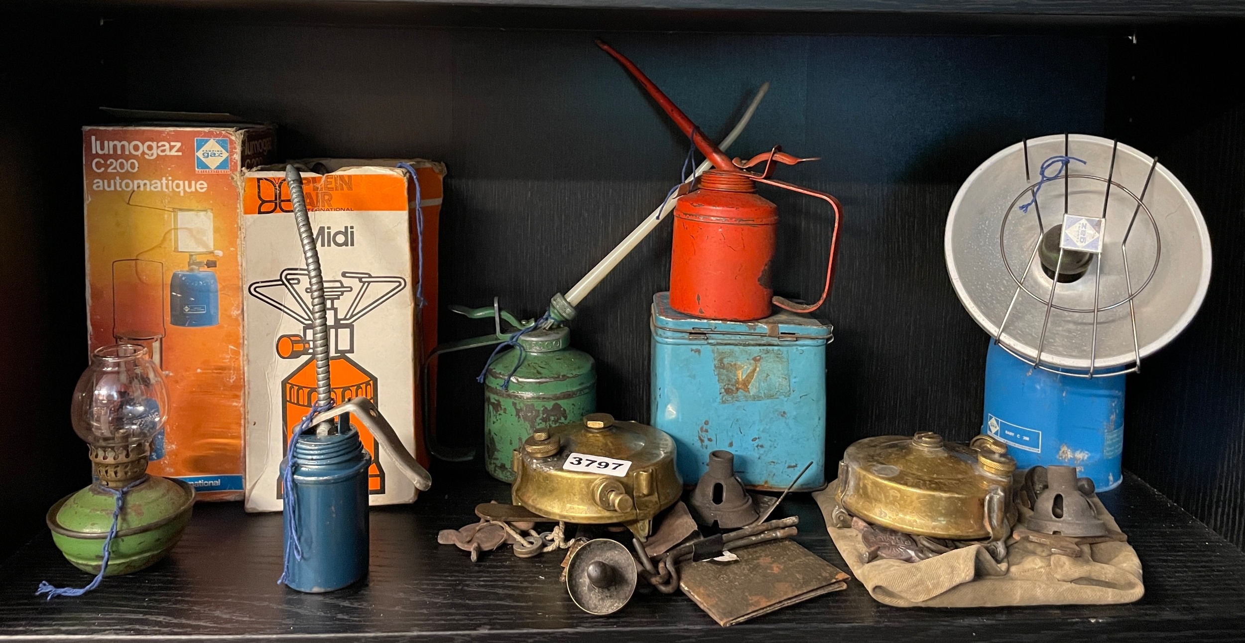 Collection of vintage camping and workshop equipment, including oil ...