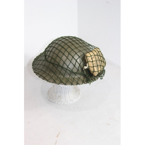 660 - WW2 BRODIE HELMET WITH FIELD DRESSING AND NET