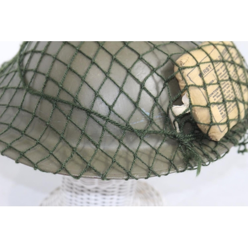 660 - WW2 BRODIE HELMET WITH FIELD DRESSING AND NET