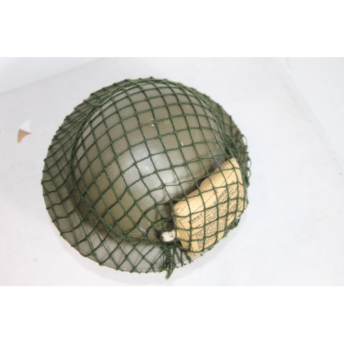 660 - WW2 BRODIE HELMET WITH FIELD DRESSING AND NET