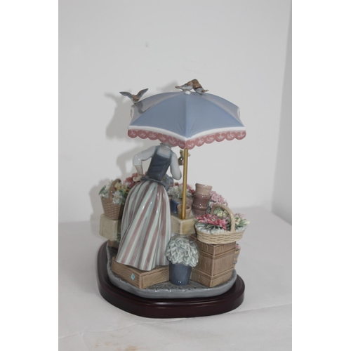 357 - LLADRO FLOWER SELLER 
27 X 33CM COUPLE OF FLOWERS ARE A/F